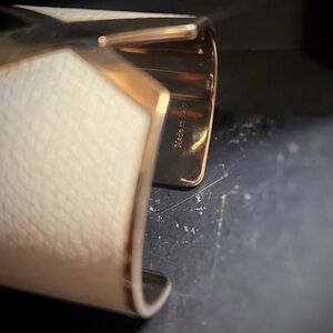 Gold-tone Valextra VX cuff with leather.